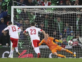 Switzerland's Ricardo Rodriguez, left, scores the opening goal from the penalty spot during the World Cup qualifying play-off first leg soccer match between Northern Ireland and Switzerland at Windsor Park in Belfast, Northern Ireland, Thursday Nov. 9, 2017.(Brian Lawless/PA via AP)