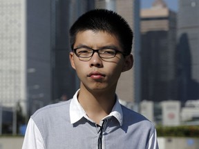 FILE - In this Nov. 1, 2017 file photo, young Hong Kong democracy activist Joshua Wong listens to questions during an interview outside the legislative council in Hong Kong. Hong Kong's top court on Tuesday, Nov. 7, 2017 has granted a bid by Wong to appeal his prison sentence. Tuesday's decision gives Wong and fellow activist Nathan Law one last chance to fight their prison terms for involvement in an unlawful assembly that sparked huge 2014 pro-democracy protests in the Chinese-controlled city. (AP Photo/Kin Cheung, File)