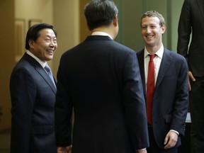 FILE - In this Sept. 23, 2015, file photo, Chinese President Xi Jinping, center, talks with Facebook Chief Executive Mark Zuckerberg, right, as Lu Wei, left, China's Internet czar, looks on during a gathering of CEOs and other executives at Microsoft's main campus in Redmond, Wash. China's former top internet regulator and censor Lu Wei is being investigated by the ruling Communist Party's anti-corruption arm, the agency said Tuesday, Nov. 21, 2017. (AP Photo/Ted S. Warren, Pool, File)