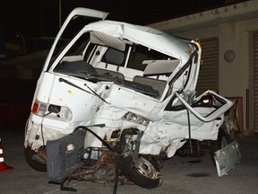 A Japanese driver's damaged vehicle is placed at a police station in Naha, Okinawa, southern Japan Sunday, Nov. 19, 2017. Police on the southern Japanese island of Okinawa are investigating a fatal traffic accident that occurred Sunday when a truck driven by a U.S. Marine collided with the small truck at an intersection, killing the Japanese driver of the other vehicle. (Kazuki Sawada/Kyodo News via AP)