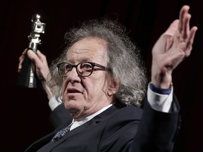 FILE - In this Feb. 11, 2017 file photo, Australian actor Geoffrey Rush poses with his 'Berlinale Camera Award' wich he received prior to the screening of the film 'Final Portrait' at the 2017 Berlinale Film Festival in Berlin, Germany. The Sydney Theatre Company says it received a complaint of "inappropriate behavior" against Rush, an allegation lawyers for the Oscar winner denied. The company wasn't disclosing details of the behavior alleged to have occurred while the 66-year-old Australian actor was an employee. Media reports say the allegation dated from the theater's production of "King Lear," about two years ago. His lawyers deny Rush was involved in inappropriate behavior. (AP Photo/Michael Sohn, File)
