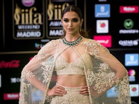 FILE - In this June 25, 2016 file photo, Bollywood actress Deepika Padukone poses for photographers at the International Indian Film Academy Rocks Green Carpet for the 17th Edition of IIFA Weekend & Awards in Madrid, Spain. A member of India's Hindu nationalist ruling party has offered a 100 million rupee ($1.5 million) reward to anyone who beheads the lead actress Padukone and  Sanjay Leela Bhansali, the director of the yet-to-be released Bollywood film "Padmavati" over its alleged handling of the relationship between a Hindu queen and a Muslim ruler.  The film's producers postponed the release of the film, which was set to be in theaters Dec. 1, 2017. (AP Photo/Samuel de Roman, File)