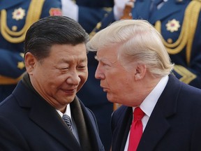 FILE - In this Nov. 9, 2017, file photo, U.S. President Donald Trump, right, chats with Chinese President Xi Jinping during a welcome ceremony at the Great Hall of the People in Beijing. Following Trump's visit to Beijing, China says it's sending a high-level special envoy to North Korea amid an extended chill in relations between the neighbors over Pyongyang's nuclear weapons and missile programs. The official Xinhua News Agency said Wednesday, Nov. 15, 2017, that director of the ruling Communist Party's International Liaison Department, Song Tao, would travel to Pyongyang on Friday to report on the party's national congress held in October. (AP Photo/Andy Wong, File)
