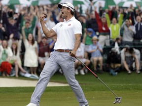 FILE - In this April 14, 2013, file photo, Adam Scott of Australia celebrates after a birdie putt on the 18th green during the fourth round of the Masters golf tournament in Augusta, Ga. Scott, whose world ranking has slid to No. 31, said Wednesday, Nov. 29, 2017, he will use a long-handled putter at the Australian PGA, similar to the now-banned broomstick version that he won the Masters with in 2013. He switched to a short putter from the broomstick one after a ban began in 2016 on anchoring the putter against the body. (AP Photo/David J. Phillip, File)