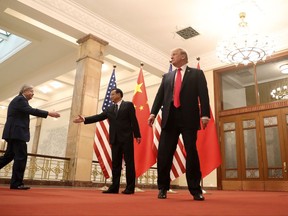 U.S. President Donald Trump and U.S. Ambassador to China Terry Branstad, left, are welcomed by Chinese Premier Li Keqiang, center, for a meeting at the Great Hall of the People, Thursday, Nov. 9, 2017, in Beijing. Trump is on a five-country trip through Asia traveling to Japan, South Korea, China, Vietnam and the Philippines. (AP Photo/Andrew Harnik)