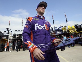 Denny Hamlin walks to the garage during a practice session for Sunday's NASCAR Cup series auto race at Texas Motor Speedway in Fort Worth, Texas, Friday, Nov. 3, 2017. (AP Photo/LM Otero)