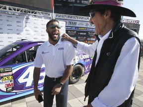 Darrell Wallace Jr., left, laughs with Richard Petty after unveiling the paint scheme for Wallace's car before NASCAR Cup series auto race qualifying at Texas Motor Speedway in Fort Worth, Texas, Friday, Nov. 3, 2017. Richard Petty Motorsports announced that Wallace Jr. will drive the No. 43 car for the organization beginning in 2018. (AP Photo/LM Otero)