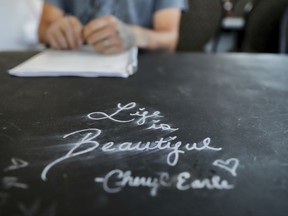 An inspirational message is written on a desk as Dalton Duncan, seated, attends a class with his wife, Whitney, as part of their mandated enrollment in the county's family drug court program in Jasper, Ga., Monday, June 26, 2017. The couple was given a choice after failing a drug screening in 2016; lose their daughter to foster care or temporarily give her to a family member while they enter the two-year program to help with their opioid addiction. (AP Photo/David Goldman)