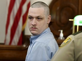 John Dylan Adams looks back at family members after recess was called during a hearing to set a date for his trial in the kidnapping, rape, and murder of Holly Bobo, who disappeared from her rural home more than six years ago, Tuesday, Nov. 14, 2017, in Savannah, Tenn. (Kenneth Cummings/The Jackson Sun via AP)