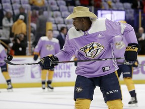 Nashville Predators defenseman P.K. Subban wears a cowboy hat along with his purple warmup jersey for the NHL's Hockey Fights Cancer program before an NHL hockey game between the Predators and the Washington Capitals, Tuesday, Nov. 14, 2017, in Nashville, Tenn. (AP Photo/Mark Humphrey)