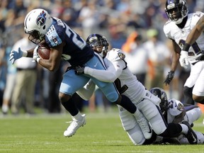 Tennessee Titans cornerback Adoree' Jackson (25) is stopped by Baltimore Ravens free safety Eric Weddle (32) in the first half of an NFL football game Sunday, Nov. 5, 2017, in Nashville, Tenn. (AP Photo/Wade Payne)
