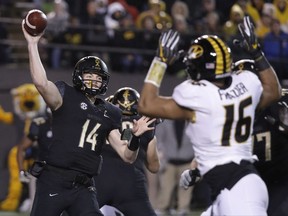 Vanderbilt quarterback Kyle Shurmur (14) passes as he is pressured by Missouri defensive lineman Marcell Frazier (16) in the first half of an NCAA college football game Saturday, Nov. 18, 2017, in Nashville, Tenn. (AP Photo/Mark Humphrey)