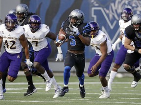 Memphis wide receiver Anthony Miller (3) runs past East Carolina defenders as he scores a touchdown on an 89-yard pass play in the first half of an NCAA college football game, Saturday, Nov. 25, 2017, in Memphis, Tenn. (AP Photo/Mark Humphrey)