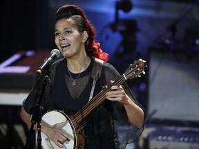 FILE - In this Sept. 13, 2017 file photo, Rhiannon Giddens performs during the Americana Honors and Awards show in Nashville, Tenn. As a singer, songwriter and instrumentalist, Giddens crosses musical divides. The versatile 40-year-old performer is winning accolades while casting a spotlight on African-American contributions to early American music. This year she was awarded $625,000 "genius grant" from the MacArthur Foundation. (AP Photo/Mark Zaleski, File)