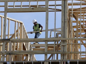 HOLD FOR SWAYNE HALL -- In this Friday, Oct. 6, 2017 photo, workers build an apartment and retail complex in Nashville, Tenn. On Wednesday, Nov. 1, 2017, the Commerce Department reports on U.S. construction spending in September. (AP Photo/Mark Humphrey)