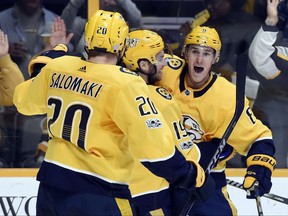 Nashville Predators center Kyle Turris, right, celebrates with center Calle Jarnkrok (19), of Sweden, right wing Miikka Salomaki (20), of Finland, after scoring a goal against the Pittsburgh Penguins during the second period of an NHL hockey game Saturday, Nov. 11, 2017, in Nashville, Tenn. (AP Photo/Mark Zaleski)