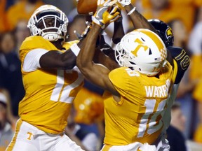 Tennessee defensive back Emmanuel Moseley (12) and defensive back Nigel Warrior (18) break up a pass intended for Southern Mississippi wide receiver Korey Robertson (18) in the first half of an NCAA college football game Saturday, Nov. 4, 2017, in Knoxville, Tenn. (AP Photo/Wade Payne)