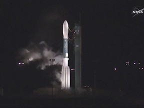 In this photo from NASA TV, a new type of U.S. weather satellite, intended to improve the accuracy of extended forecasts, sits on a launch pad at Vandenberg Air Force Base, Calif., Tuesday, Nov. 14, 2017. A press release from the base said the planned launch was scrubbed early Tuesday because of an unspecified issue and managers didn't have enough time to resolve it. (NASA TV via AP)
