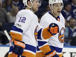 New York Islanders left wing Anders Lee (27) celebrates his goal against the Tampa Bay Lightning with right wing Josh Bailey (12) during the first period of an NHL hockey game Saturday, Nov. 18, 2017, in Tampa, Fla. (AP Photo/Chris O'Meara)