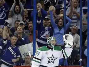 Dallas Stars goalie Ben Bishop (30) waves to the crowd after a video tribute to him during the first period of an NHL hockey game against the Tampa Bay Lightning, Thursday, Nov. 16, 2017, in Tampa, Fla. Bishop is a former member of the Lightning. (AP Photo/Chris O'Meara)