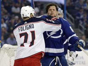 Columbus Blue Jackets left wing Nick Foligno (71) lands a punch to Tampa Bay Lightning defenseman Jake Dotchin during the first period of an NHL hockey game Saturday, Nov. 4, 2017, in Tampa, Fla. (AP Photo/Chris O'Meara)