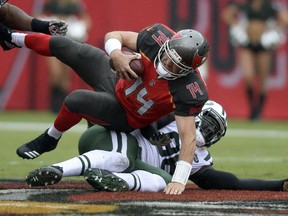 Tampa Bay Buccaneers quarterback Ryan Fitzpatrick (14) is sacked by New York Jets defensive end Muhammad Wilkerson (96) during the first half of an NFL football game Sunday, Nov. 12, 2017, in Tampa, Fla. (AP Photo/Jason Behnken)