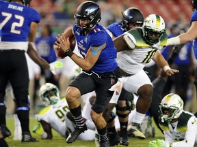 Tulsa quarterback Luke Skipper (13) scrambles for a touchdown past South Florida defender Deadrin Senat (10) during the first half of an NCAA college football game Thursday, Nov. 16, 2017, in Tampa, Fla. (AP Photo/Steve Nesius)