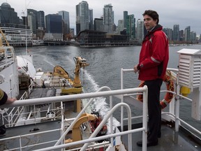 Prime Minister Justin Trudeau stands on board the Canadian Coast Guard ship Sir Wilfrid Laurier, during a tour of the harbour in Vancouver, B.C.