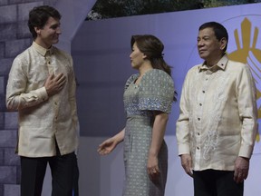 Prime Minister Justin Trudeau speaks with  Honeylet Avancena and Philippine President Rodrigo Duterte and as he arrives at the 50th Anniversary celebration of the Association of Southeast Asian Nations in Manila, Philippines Sunday November 12, 2017.