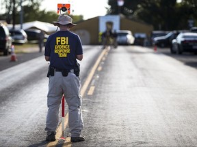 A member of the FBI's Evidence Response Team works on the crime scene of the mass shooting at the First Baptist Church in Sutherland Springs, Texas on Monday, Nov. 6, 2017. (Nick Wagner/Austin American-Statesman via AP)