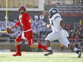 Texas Tech's Nic Shimonek (16) runs away from TCU's Joseph Broadnax Jr. during the first half of an NCAA college football game, Saturday, Nov. 18, 2017, in Lubbock, Texas. (AP Photo/Brad Tollefson)
