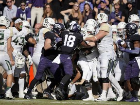 TCU safety Nick Orr (18) and Baylor's sideline erupts into a shoving match during the second half of an NCAA college football game, Friday, Nov. 24, 2017, in Fort Worth, Texas. TCU won 45-22. (AP Photo/Brandon Wade)