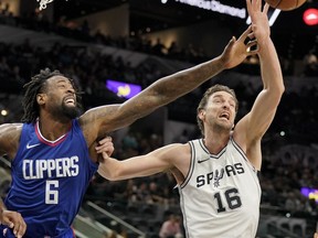 Los Angeles Clippers center DeAndre Jordan (6) chases the rebound against San Antonio Spurs' Pau Gasol, of Spain, during the first half of an NBA basketball game, Tuesday, Nov. 7, 2017, in San Antonio. (AP Photo/Darren Abate)