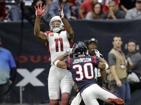 Arizona Cardinals wide receiver Larry Fitzgerald (11) reaches for the ball to make a touchdown catch over Houston Texans cornerback Kevin Johnson (30) during the first half of an NFL football game, Sunday, Nov. 19, 2017, in Houston. (AP Photo/David J. Phillip)