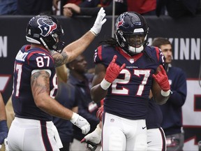 Houston Texans running back D'Onta Foreman (27) celebrates with teammates after a touchdown run during the second half of an NFL football game against the Arizona Cardinals, Sunday, Nov. 19, 2017, in Houston. (AP Photo/Eric Christian Smith)