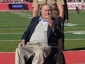 Former President George H.W. Bush acknowledges the crowd before an NCAA college football game between Navy and Houston, Friday, Nov. 24, 2017, in Houston. (AP Photo/Eric Christian Smith)