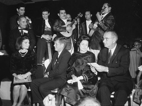 FILE - In this Nov. 21, 1963, file photo first lady Jackie Kennedy, President John F. Kennedy, Lady Bird and Vice President Lyndon Johnson attend a LULAC dinner in Houston. Newly released documents regarding John F. Kennedy's assassination show the FBI was monitoring Latino civil rights groups weeks before the president would make history by visiting with one of the organizations. A memo released October 2017 said an FBI informant kept close watch on a Dallas chapter of the G.I. Forum, a moderate group of Mexican American veterans who spoke out against discrimination. (Ted Rozumaiski/Houston Chronicle via AP, File)