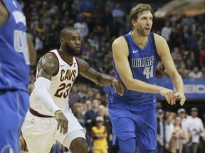 Dallas Mavericks forward Dirk Nowitzki (41), of Germany, and Cleveland Cavaliers forward LeBron James (23) play during the second half of an NBA basketball game in Dallas, Saturday, Nov. 11, 2017. (AP Photo/LM Otero)