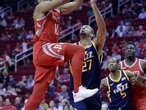 Houston Rockets guard Eric Gordon (10) loses the ball on the drive to the hoop under pressure from Utah Jazz center Rudy Gobert (27) in the first half of an NBA basketball game, Sunday, Nov. 5, 2017, in Houston. (AP Photo/Michael Wyke)