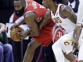 Houston Rockets guard James Harden (13) keeps the ball from the reach of Cleveland Cavaliers guard Iman Shumpert (4) during the first half of an NBA basketball game Thursday, Nov. 9, 2017, in Houston. (AP Photo/Michael Wyke)