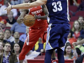 Houston Rockets forward Luc Richard Mbah a Moute (12) tries to pass the ball around Memphis Grizzlies center Marc Gasol (33) during the first half of an NBA basketball game Saturday, Nov. 11, 2017, in Houston. (AP Photo/Michael Wyke)