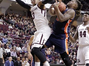 Texas A&M guard Admon Gilder (3) and Pepperdine forward Nolan Taylor (31) battle for a rebound during the first half of an NCAA college basketball game Friday, Nov. 24, 2017, in College Station, Texas. (AP Photo/Michael Wyke)