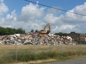This Sept. 2017 photo shows a dump site approved by the state in Port Arthur, Texas.  The temporary dumping ground used to sort moldy debris from buildings flooded after Hurricane Harvey in southeast Texas was closed following a weeks-long campaign by the neighborhood's predominantly elderly black homeowners complaining of potential health risks.  Residents and activists were celebrating after the site was closed Sunday, Oct. 29, 2017, as contractors finished their first sweep of ruined furniture and appliances left curbside in  the Gulf Coast city about 80 miles (129 kilometers) east of Houston.   (Jesse Wright/The News via AP)