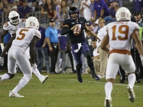 TCU quarterback Kenny Hill (7) runs for a first down as Texas defenders Holton Hill (5) and Brandon Jones (19) close in during the first half of an NCAA college football game Saturday, Nov. 4, 2017, in Fort Worth, Texas. (AP Photo/Ron Jenkins)