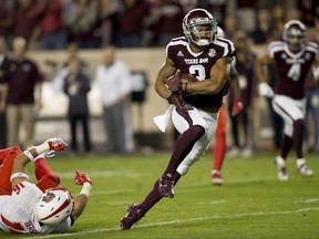Texas A&M wide receiver Christian Kirk (3) breaks away from New Mexico safety Jacob Girgle (16) for a touchdown after a catch during the first quarter of an NCAA college football game on Saturday, Nov. 11, 2017, in College Station, Texas. (AP Photo/Sam Craft)