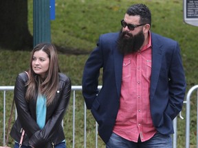 Christopher "Jake" Carrizal, right, arrives at the McLennan County courthouse with an unidentified women, Thursday, Nov. 9, 2017, in Waco, Texas. A jury started deliberating around noon after both sides of the case presented closing arguments. The Dallas chapter president of the Bandidos motorcycle club is the first to stand trial involving the 2015 shootout where nine people were fatally shot and 18 people were injured outside of Twin Peaks restaurant. (Jerry Larson/Waco Tribune Herald, via AP)