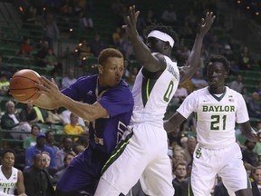 Alcorn State guard Avery Patterson (1) tries to drive past Baylor forward Jo Lual-Acuil Jr. (0) as Baylor forward Nuni Omot (21) looks on in the second half of an NCAA college basketball game, Friday, Nov. 17, 2017, in Waco, Texas. (Jerry Larson/Waco Tribune Herald, via AP)