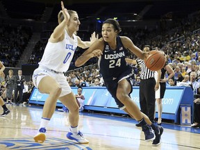 Connecticut forward Napheesa Collier (24) drives as UCLA guard Chantel Horvat (0) defends in the first quarter of an NCAA women's basketball game in Los Angeles Tuesday, Nov. 21, 2017. (AP Photo/Reed Saxon)