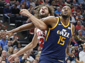 Utah Jazz forward Derrick Favors (15) and Chicago Bulls center Robin Lopez works for position under the basket during the first half of an NBA basketball game Wednesday, Nov. 22, 2017, in Salt Lake City. (AP Photo/Rick Bowmer)