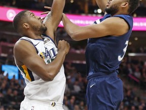 Utah Jazz forward Derrick Favors, left, defends against Minnesota Timberwolves center Karl-Anthony Towns, right, in the first half during an NBA basketball game Monday, Nov. 13, 2017, in Salt Lake City. (AP Photo/Rick Bowmer)